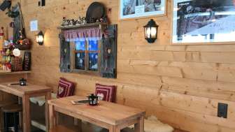 Gemütliche, alpenländisch eingerichtete Bar mit Hüttenflair